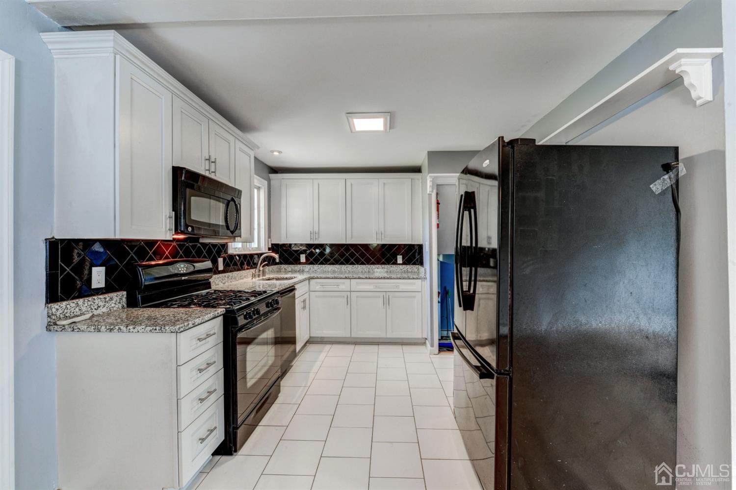 37 Finley Road Edison, NJ 08817 - Photo 10 of 29 a kitchen with a refrigerator and a sink