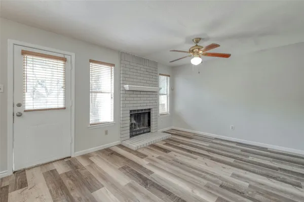 a view of empty room with fireplace and fan