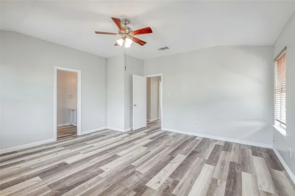 a view of a livingroom with a ceiling fan and window