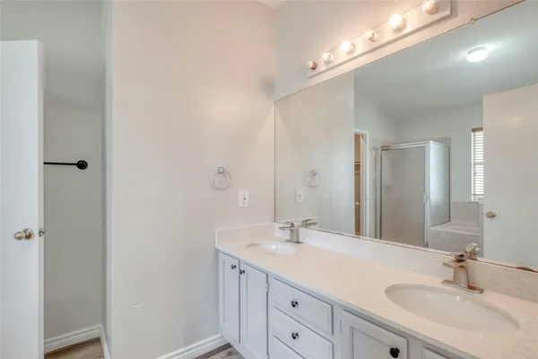a bathroom with a sink double vanity and a mirror