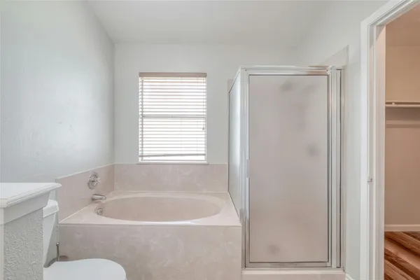 a white bath tub sitting next to a white toilet