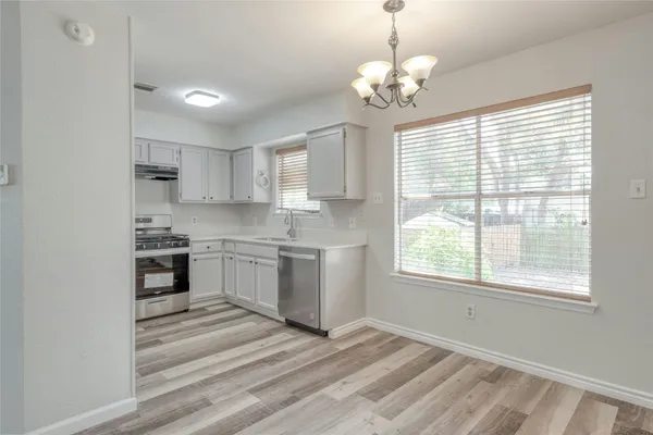 a kitchen with a refrigerator and windows