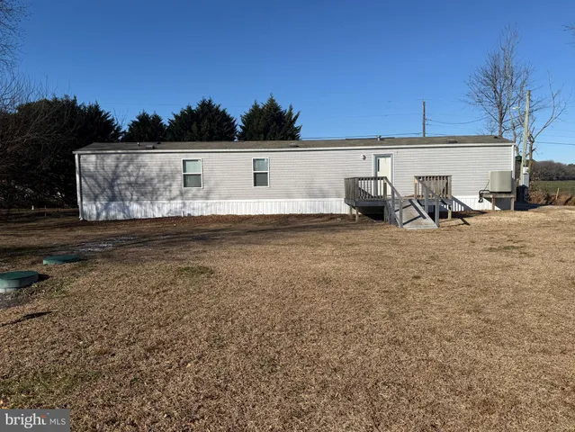 a view of a house with yard and sitting area