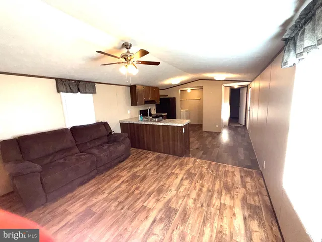a living room with a couch and chandelier