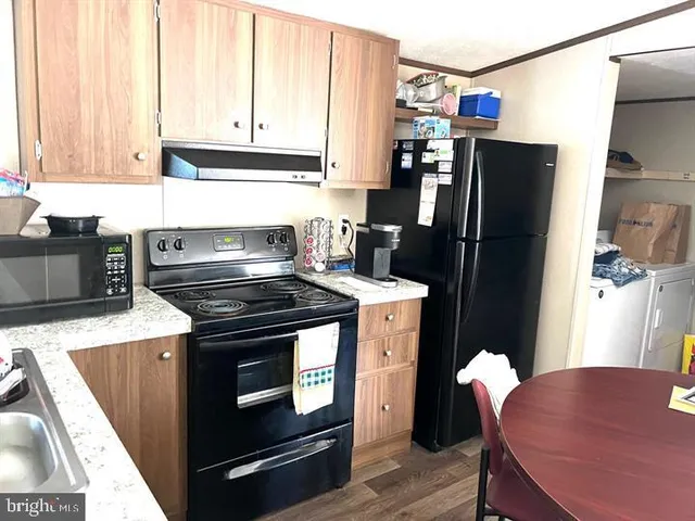 a kitchen with stainless steel appliances granite countertop a refrigerator stove and microwave