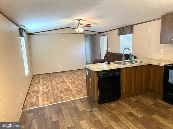 a kitchen with a sink cabinets and wooden floor