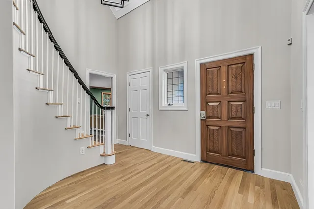 a view of entryway with stairs and wooden floor