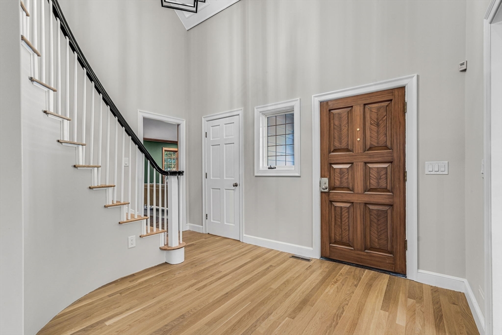 1437-3 Monument Street Concord, MA 01742 - Photo 3 of 41 a view of entryway with stairs and wooden floor
