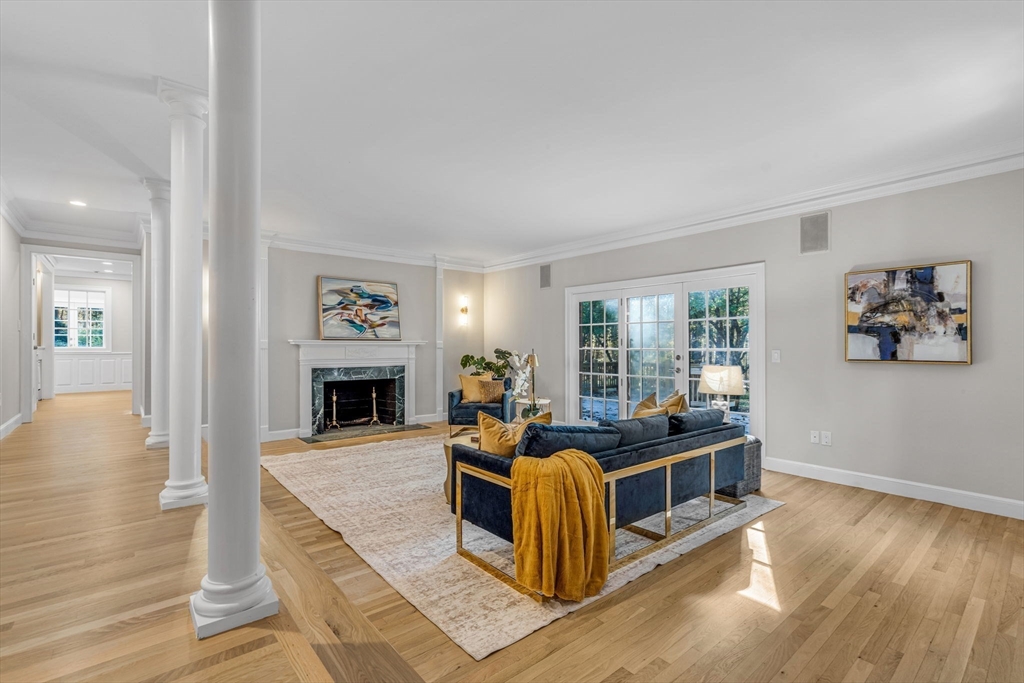1437-3 Monument Street Concord, MA 01742 - Photo 7 of 41 a living room with fireplace furniture and a wooden floor