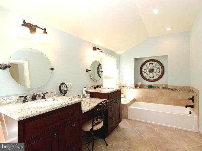 8 Midsummer Court Gaithersburg, MD 20878 - Photo 18 of 30 a bathroom with a tub sink and mirror