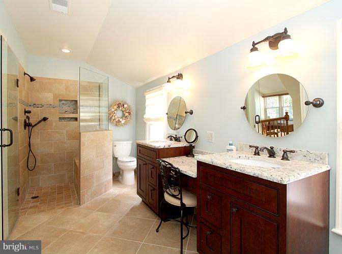 8 Midsummer Court Gaithersburg, MD 20878 - Photo 19 of 30 a spacious bathroom with a sink mirror toilet and shower