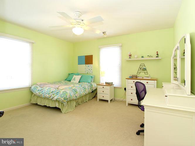 8 Midsummer Court Gaithersburg, MD 20878 - Photo 20 of 30 a spacious bedroom with a bed and a chandelier