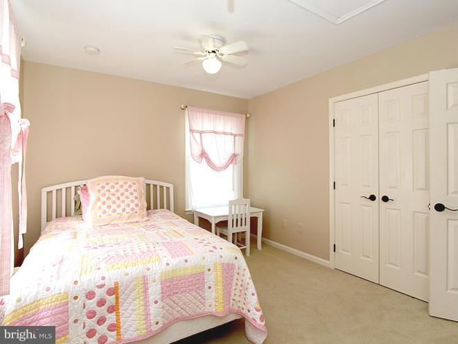 8 Midsummer Court Gaithersburg, MD 20878 - Photo 22 of 30 a bedroom with a large bed and a chandelier