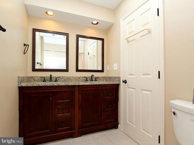 8 Midsummer Court Gaithersburg, MD 20878 - Photo 23 of 30 a bathroom with a granite countertop sink and a mirror