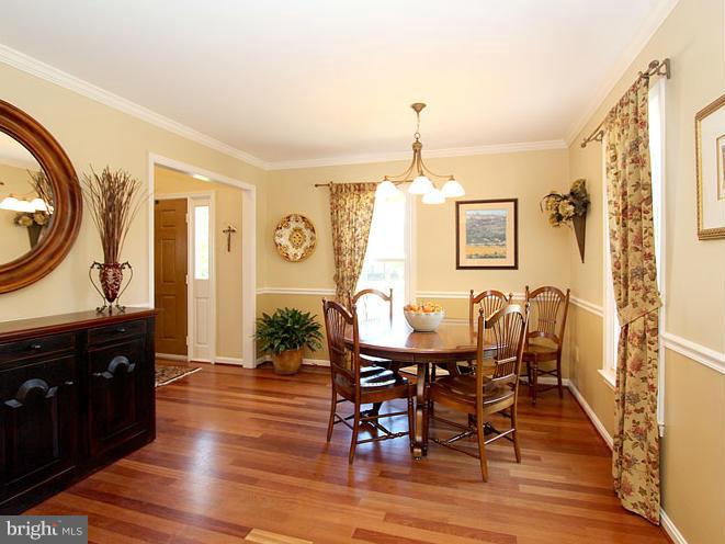 8 Midsummer Court Gaithersburg, MD 20878 - Photo 5 of 30 a view of a dining room with furniture and wooden floor