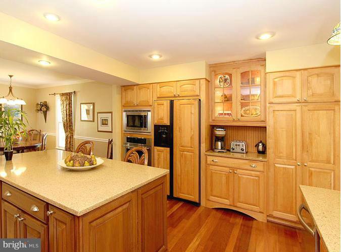 8 Midsummer Court Gaithersburg, MD 20878 - Photo 8 of 30 a kitchen with stainless steel appliances a sink cabinets and wooden floor