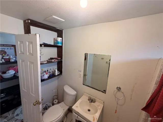 a bathroom with a toilet and a shower curtain