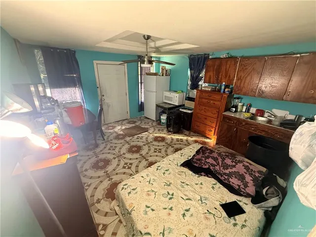 a bed room with a bed window and a chair