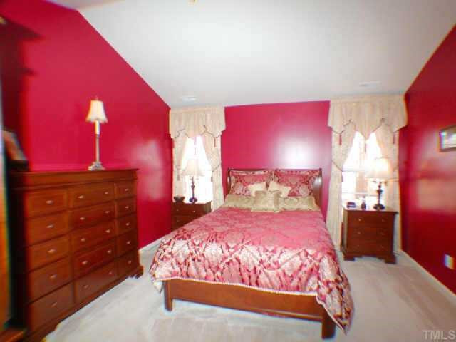Spacious and elegant Master Bedroom with cathedral ceiling; upgrades include ceiling fan and built-ins added to walk-in closet. Other