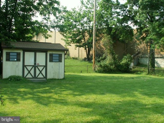 1206 Greystone Road Halethorpe, MD 21227 - Photo 2 of 10 a view of a yard with a house and large trees
