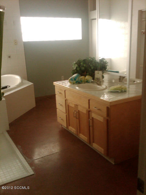 443 Rio Rico Drive Rio Rico, AZ 85648 - Photo 4 of 9 a bathroom with a sink toilet and mirror