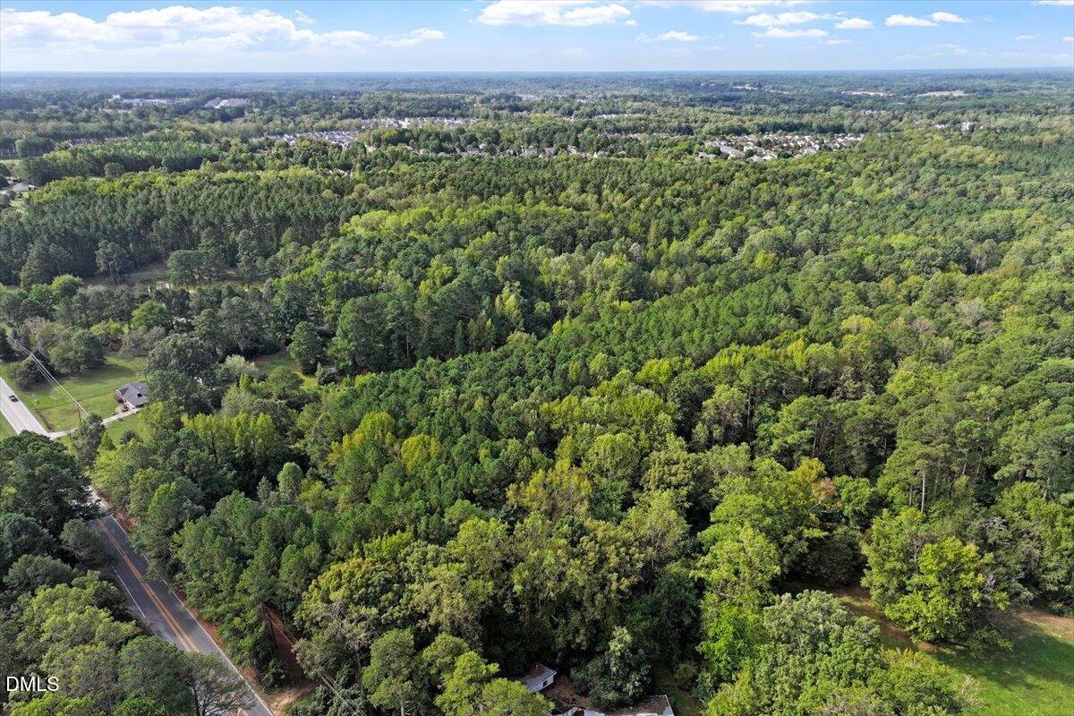 7626 White Oak Road Garner, NC 27529 - Photo 12 of 12 an aerial view of a houses with a lush green hillside