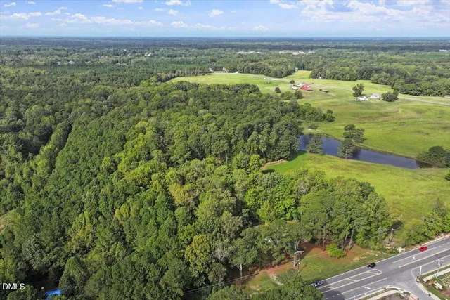 an aerial view of residential building with outdoor space and ocean view