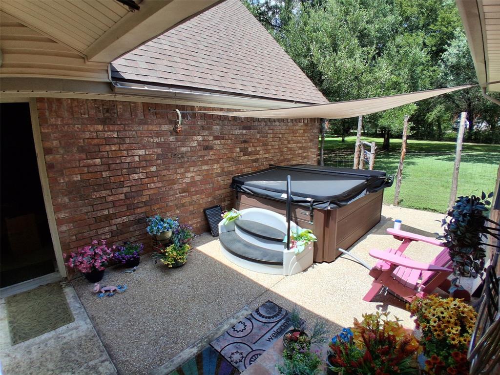 3600 Fox Ridge Road Lorena, TX 76655 - Photo 4 of 31 Outdoor patio with an integrated spa, featuring a wood-finish exterior
