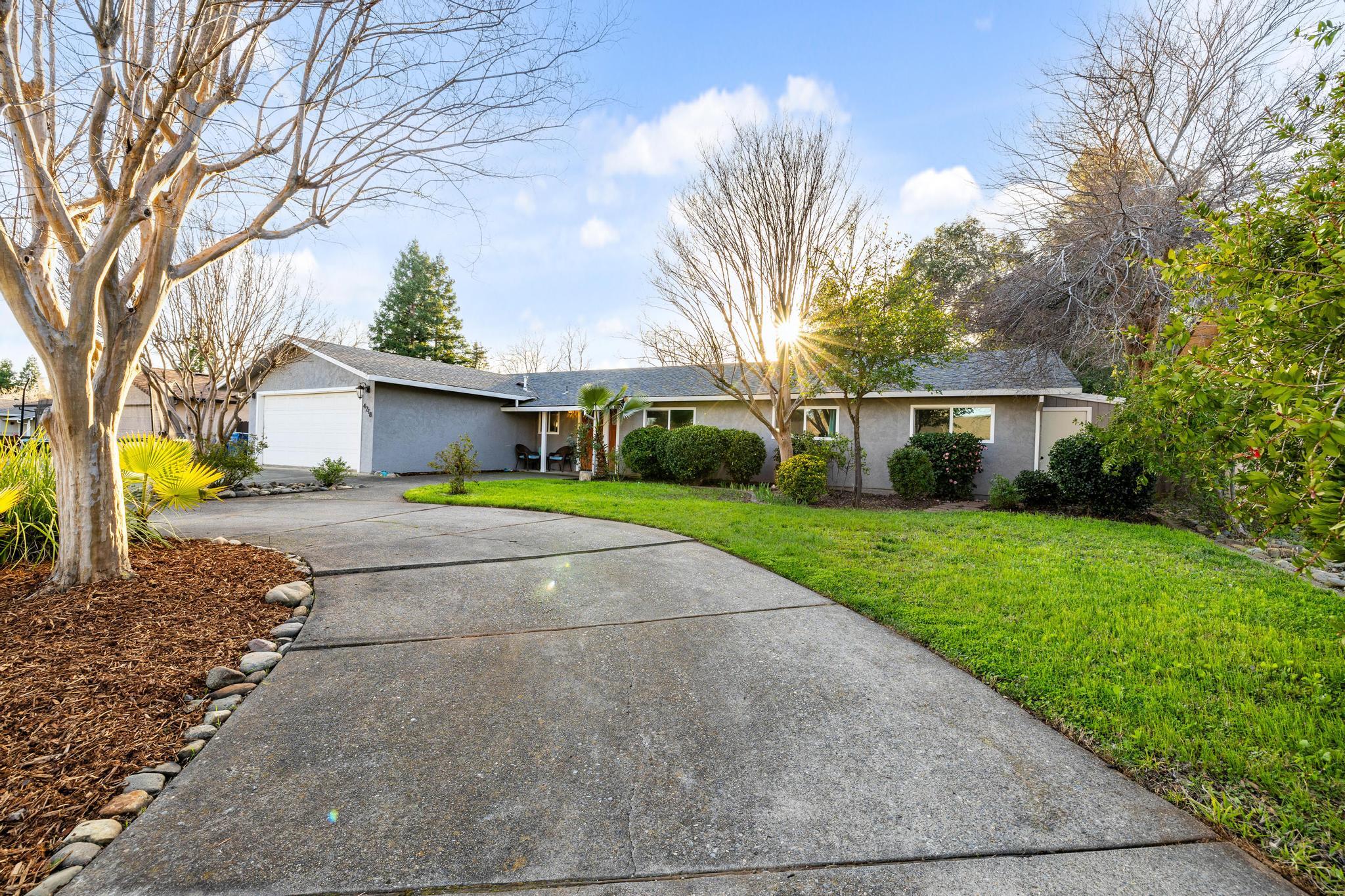 4218 Jane Street Redding, CA 96002 - Photo 2 of 50 a front view of a house with a yard and garage