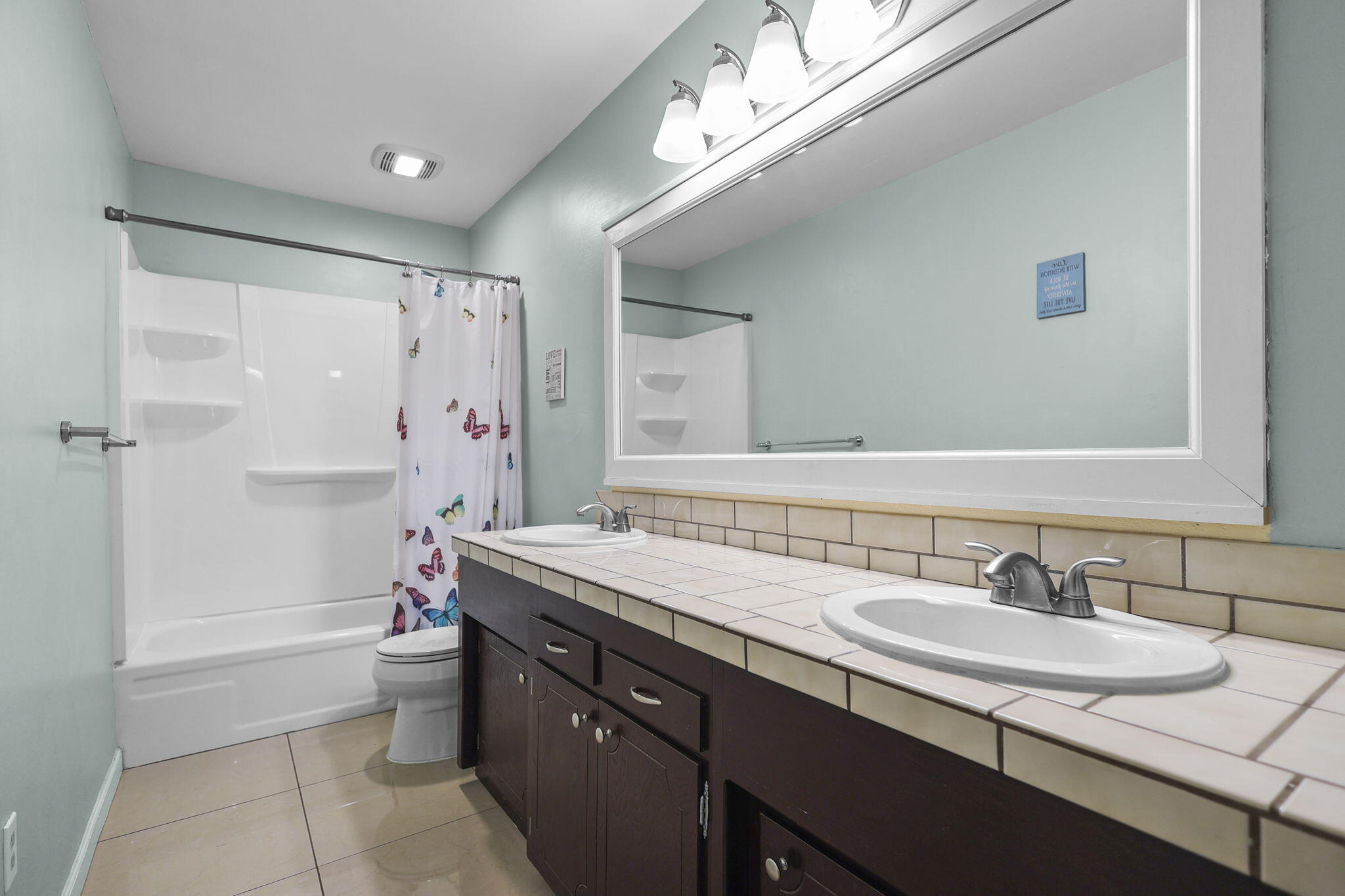 4218 Jane Street Redding, CA 96002 - Photo 22 of 50 a bathroom with a granite countertop sink a toilet a mirror and shower