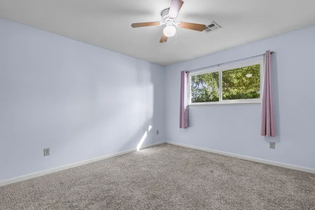 a view of an empty room with a fireplace