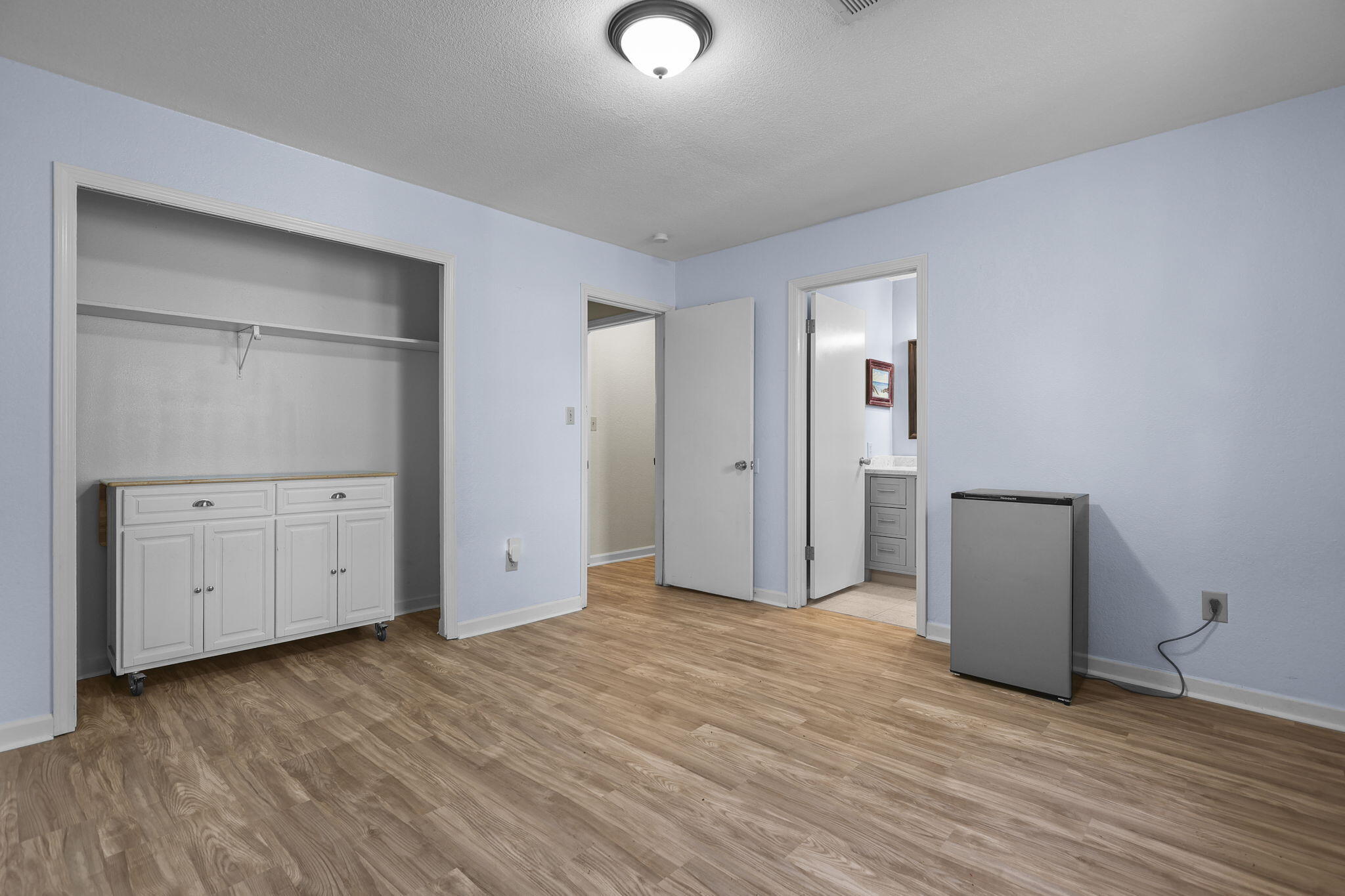 4218 Jane Street Redding, CA 96002 - Photo 33 of 50 an empty room with mirror and a wooden floor