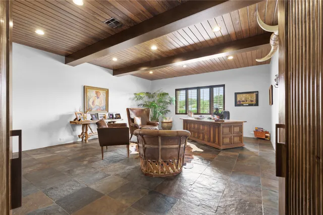 a living room with furniture and a floor to ceiling window