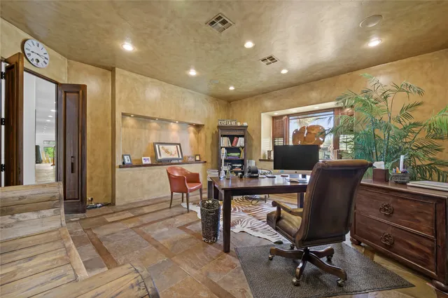 a view of a hallway to a livingroom with furniture