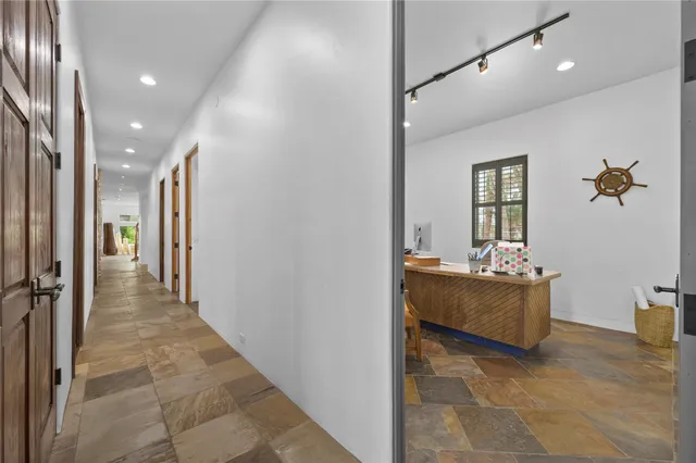 a living room with furniture and painting on the wall