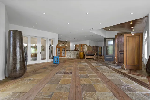 a living room with furniture and a large mirror