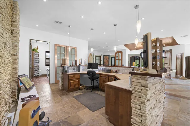 a living room with lots of furniture and kitchen view