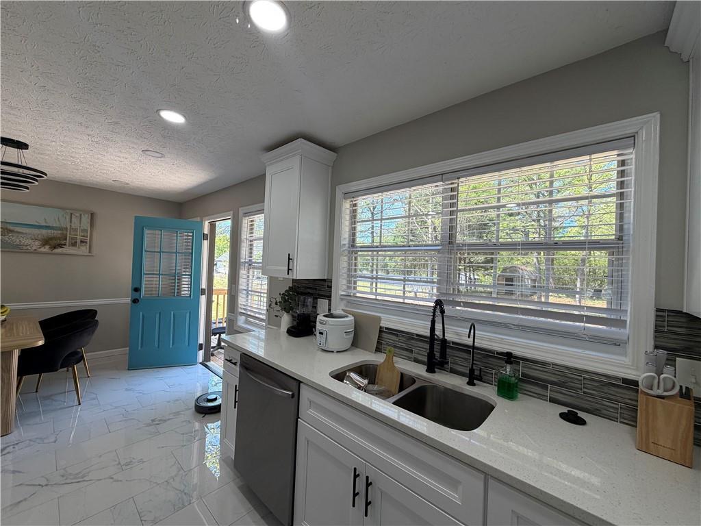 934 Bay Ridge Drive Lawrenceville, GA 30045 - Photo 24 of 78 a kitchen with a sink and wooden cabinets