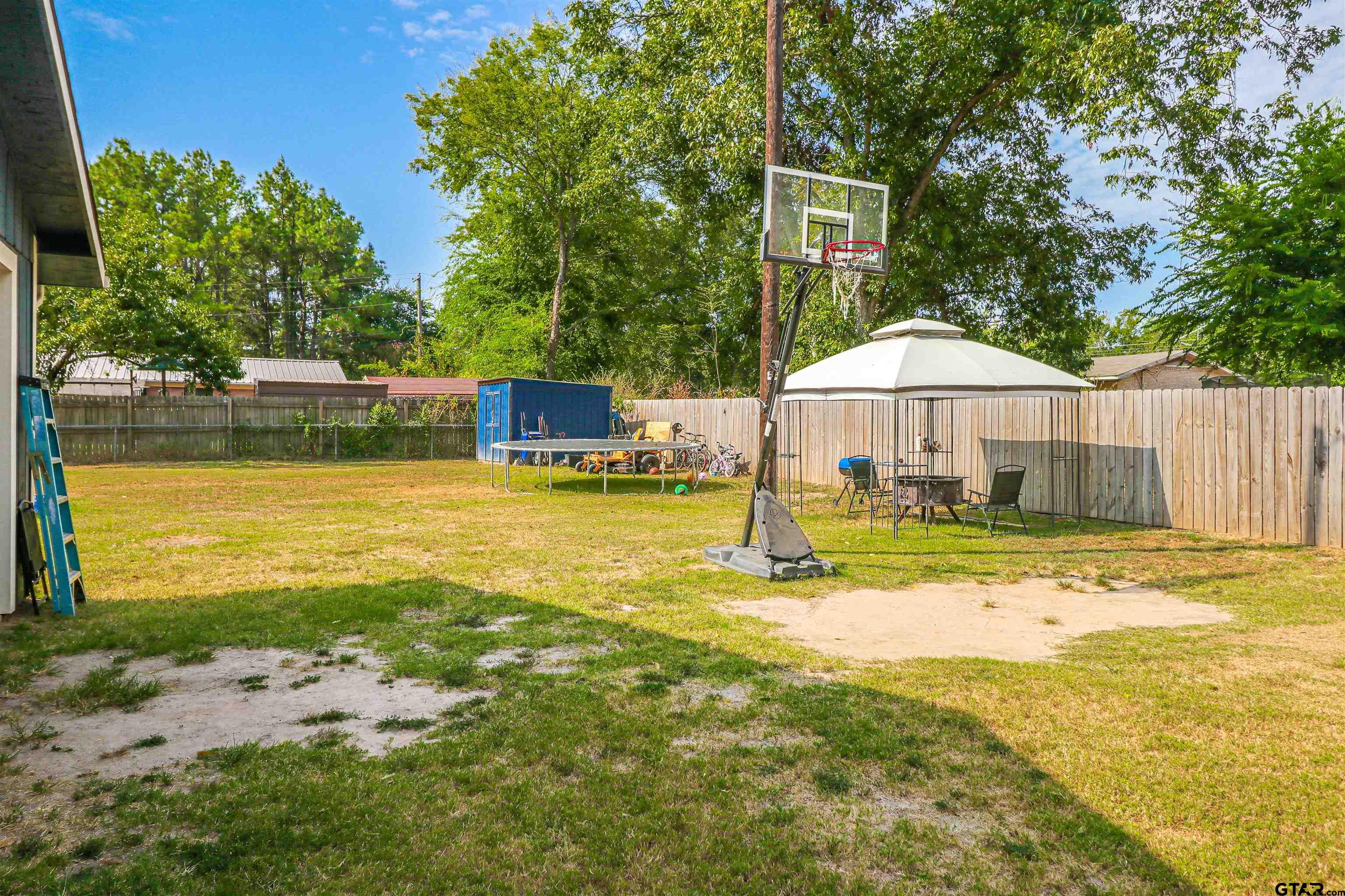 140 County Road 1541 Rusk, TX 75785 - Photo 16 of 21 a view of a swimming pool with a table and chairs under an umbrella