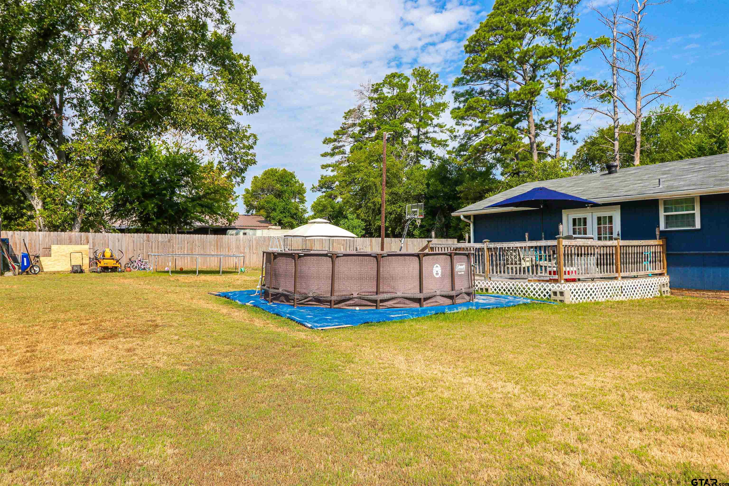 140 County Road 1541 Rusk, TX 75785 - Photo 18 of 21 a view of a swimming pool with lawn chairs and plants