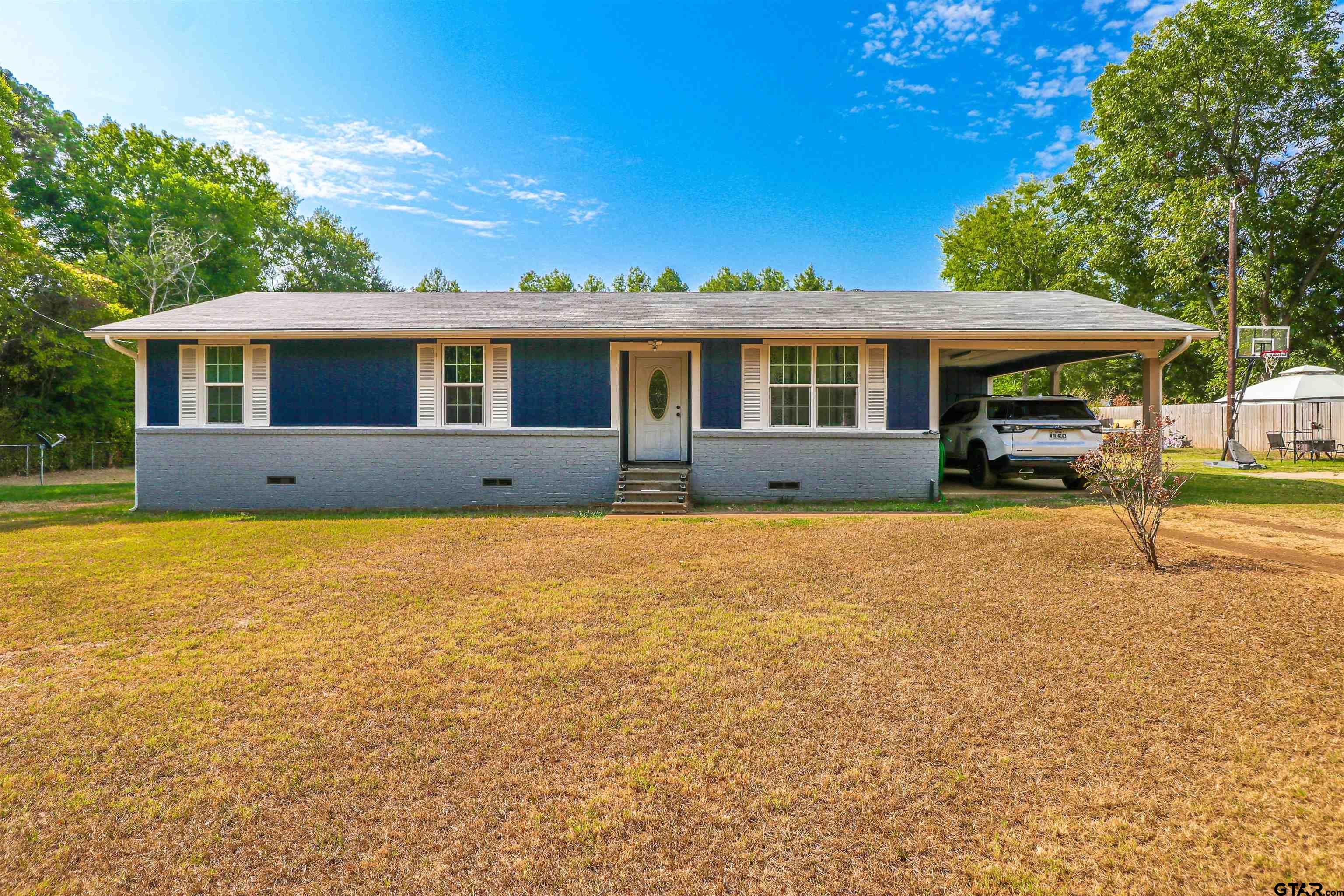 140 County Road 1541 Rusk, TX 75785 - Photo 2 of 21 a front view of a house with garden