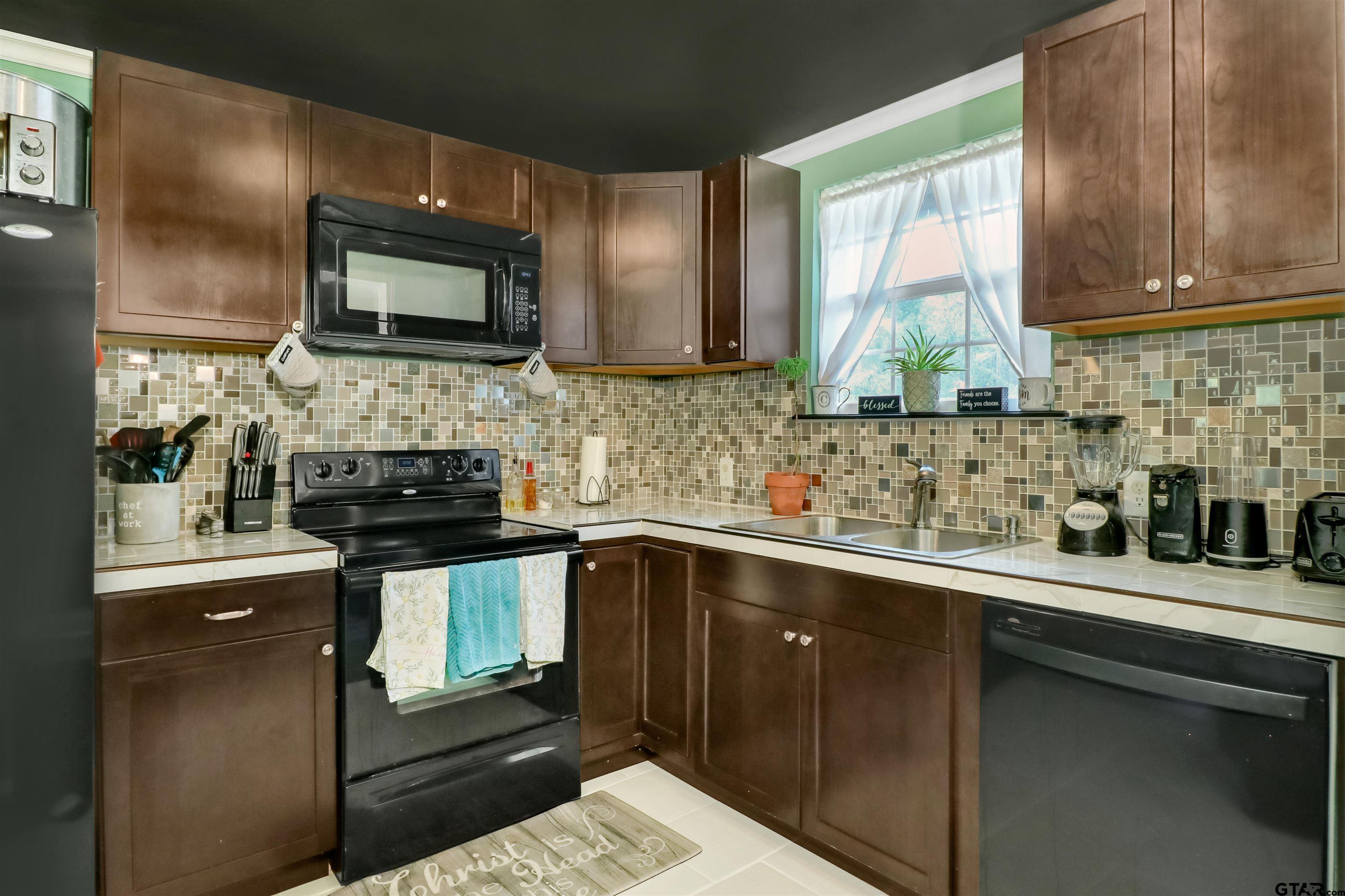 140 County Road 1541 Rusk, TX 75785 - Photo 3 of 21 a kitchen with a sink and stainless steel appliances