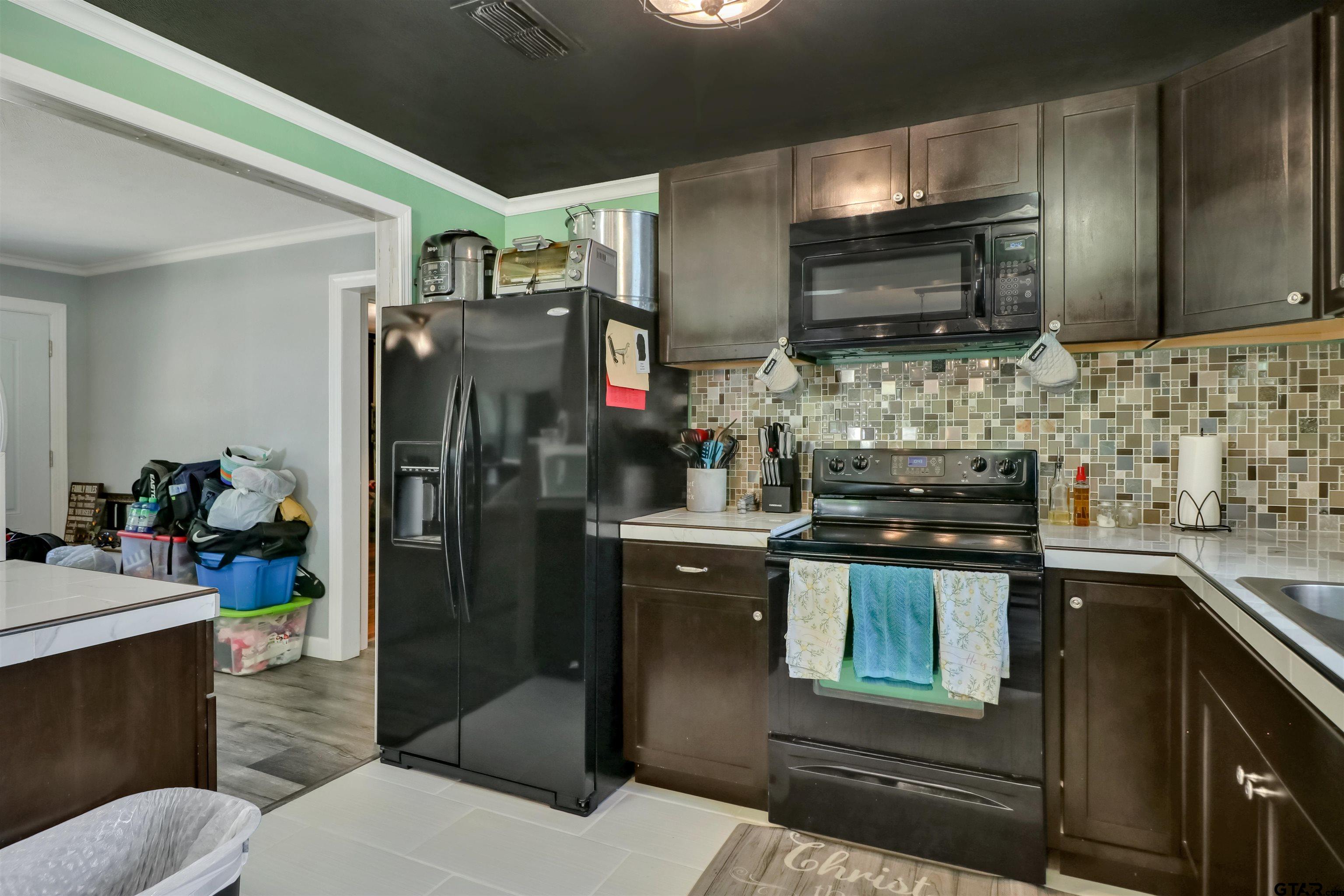 140 County Road 1541 Rusk, TX 75785 - Photo 4 of 21 a kitchen with stainless steel appliances granite countertop a refrigerator and a stove top oven