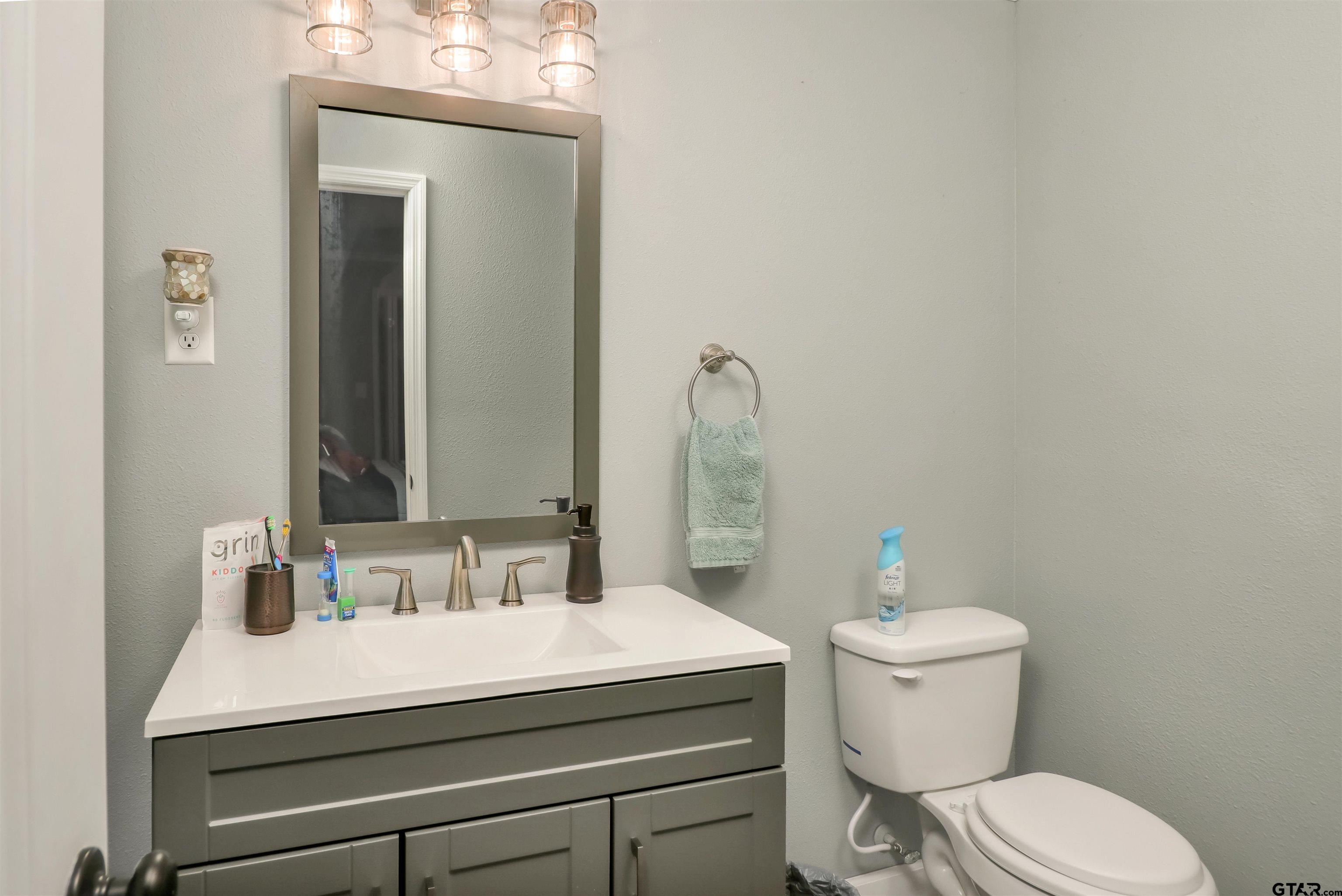 140 County Road 1541 Rusk, TX 75785 - Photo 9 of 21 a bathroom with a sink vanity mirror and toilet