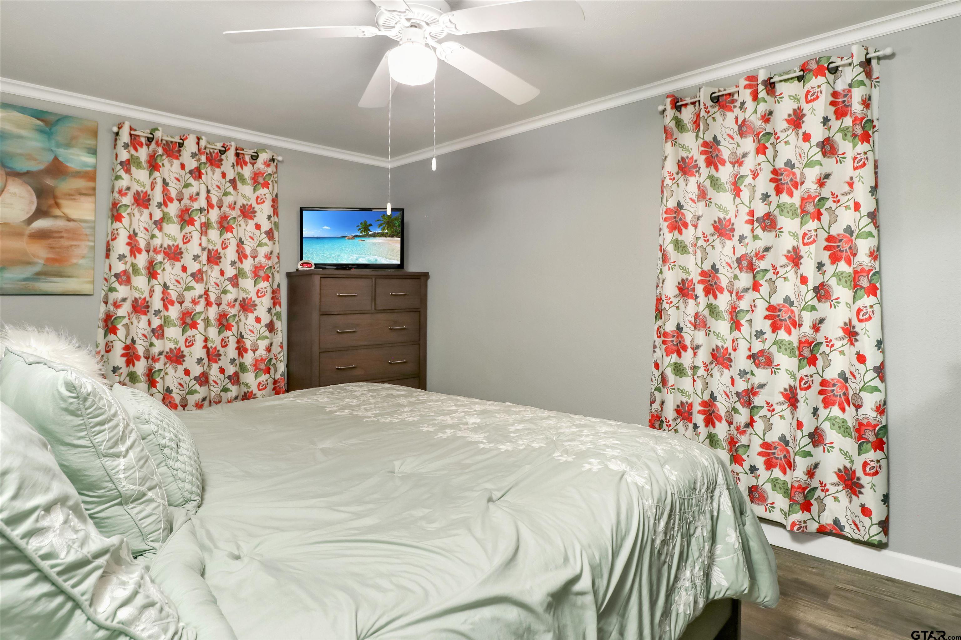 140 County Road 1541 Rusk, TX 75785 - Photo 10 of 21 a bedroom with a bed and a chandelier