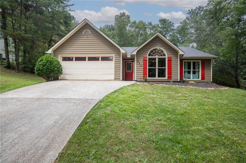 a front view with a house and a yard