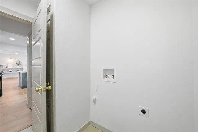 an empty room with a window and wooden floor