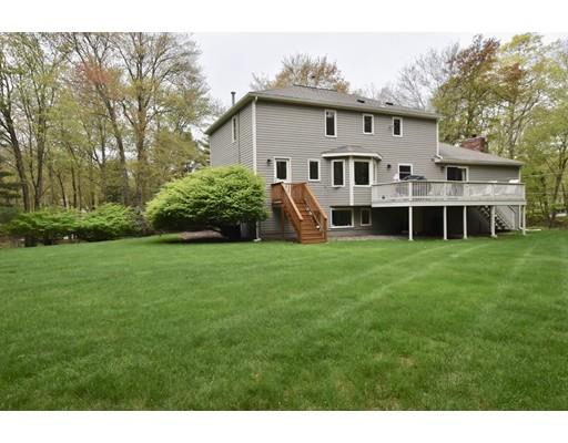 25 Azalea Road Sharon, MA 02067 - Photo 21 of 21 a view of a white house with a big yard and potted plants and large trees