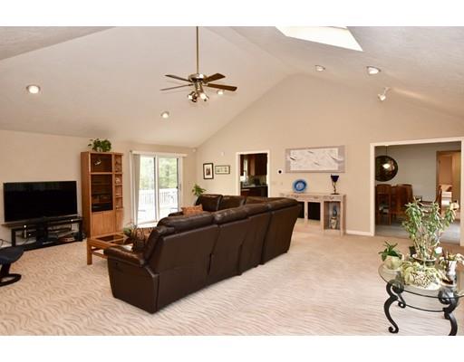 25 Azalea Road Sharon, MA 02067 - Photo 7 of 21 a living room with furniture a flat screen tv and kitchen view