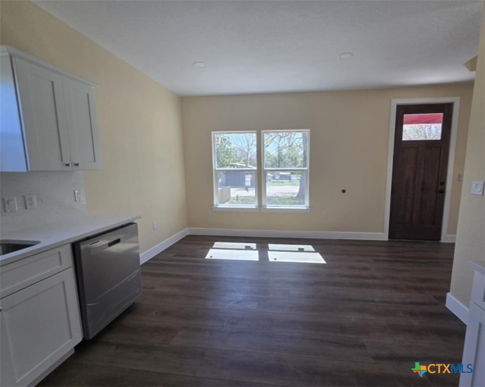 410 Trinity Street Luling, TX 78648 - Photo 5 of 10 a view of an empty room with wooden floor and a window